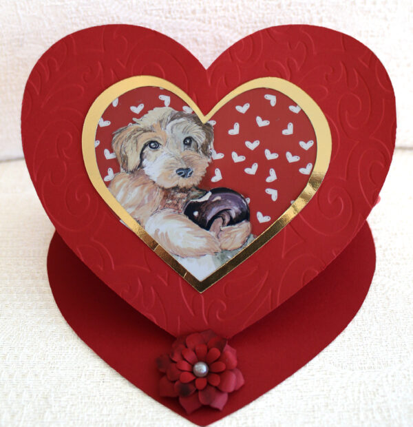 "Be my valentine greeting card " is a heart shaped greeting card featuring the painting by EW. Movileanu of a watercolor puppy holding a sweet donut.